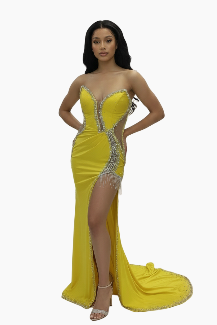 Woman wearing a yellow evening gown with a high slit on a white background