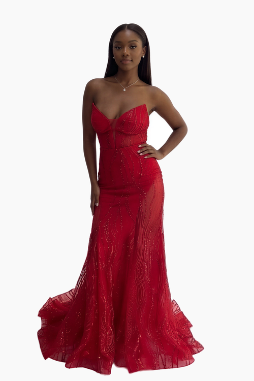 Woman wearing a red strapless evening gown on a white background