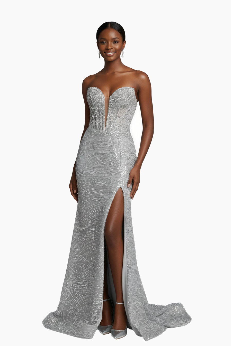 Woman wearing a silver beaded evening gown with a high slit on a white background