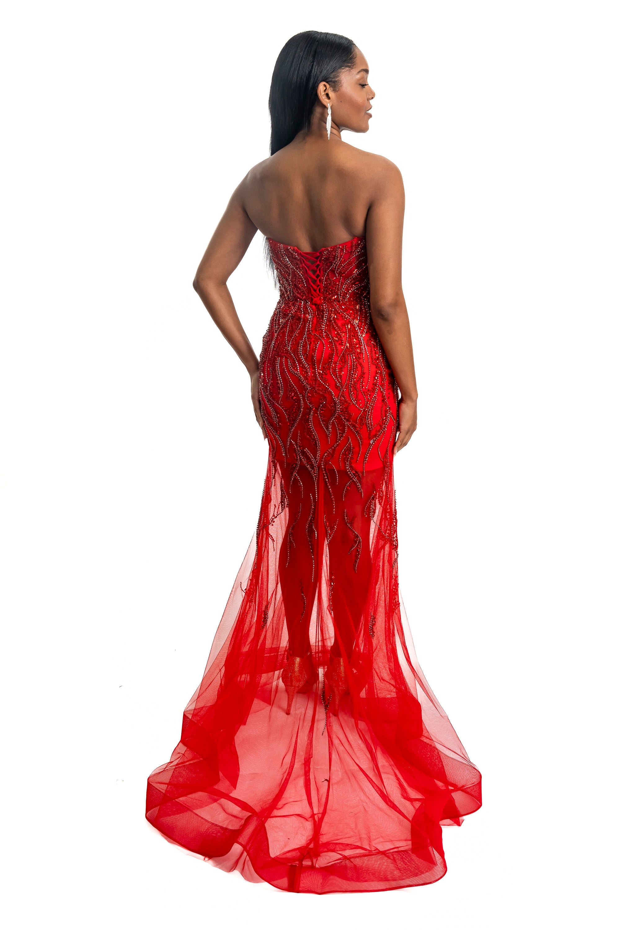 Red evening gown with intricate detailing on a white background