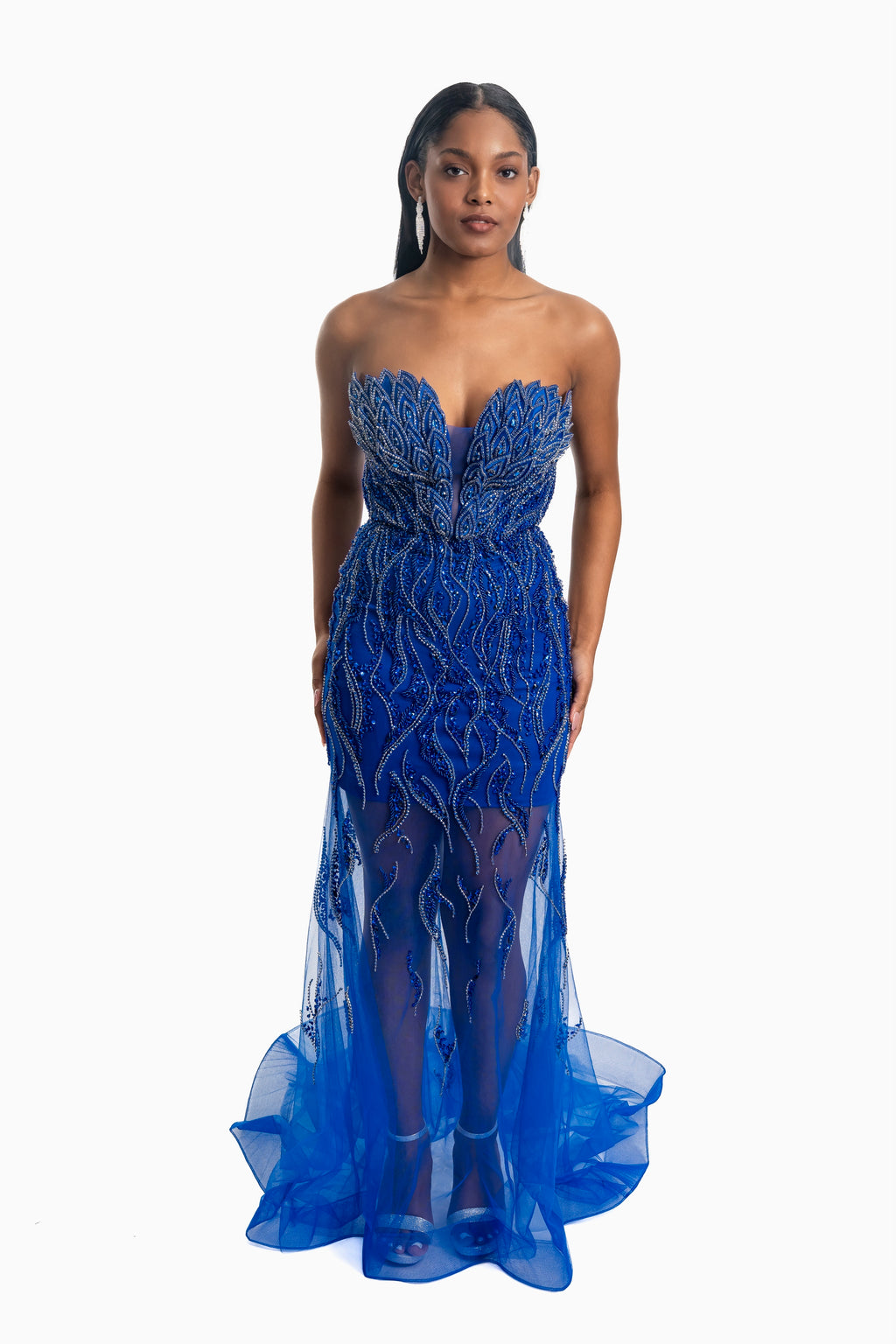 Woman wearing a blue strapless gown with intricate detailing on a white background